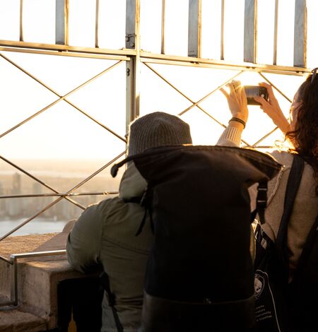 People overlooking the view on the 86th Floor of the Empire State Building Observatory