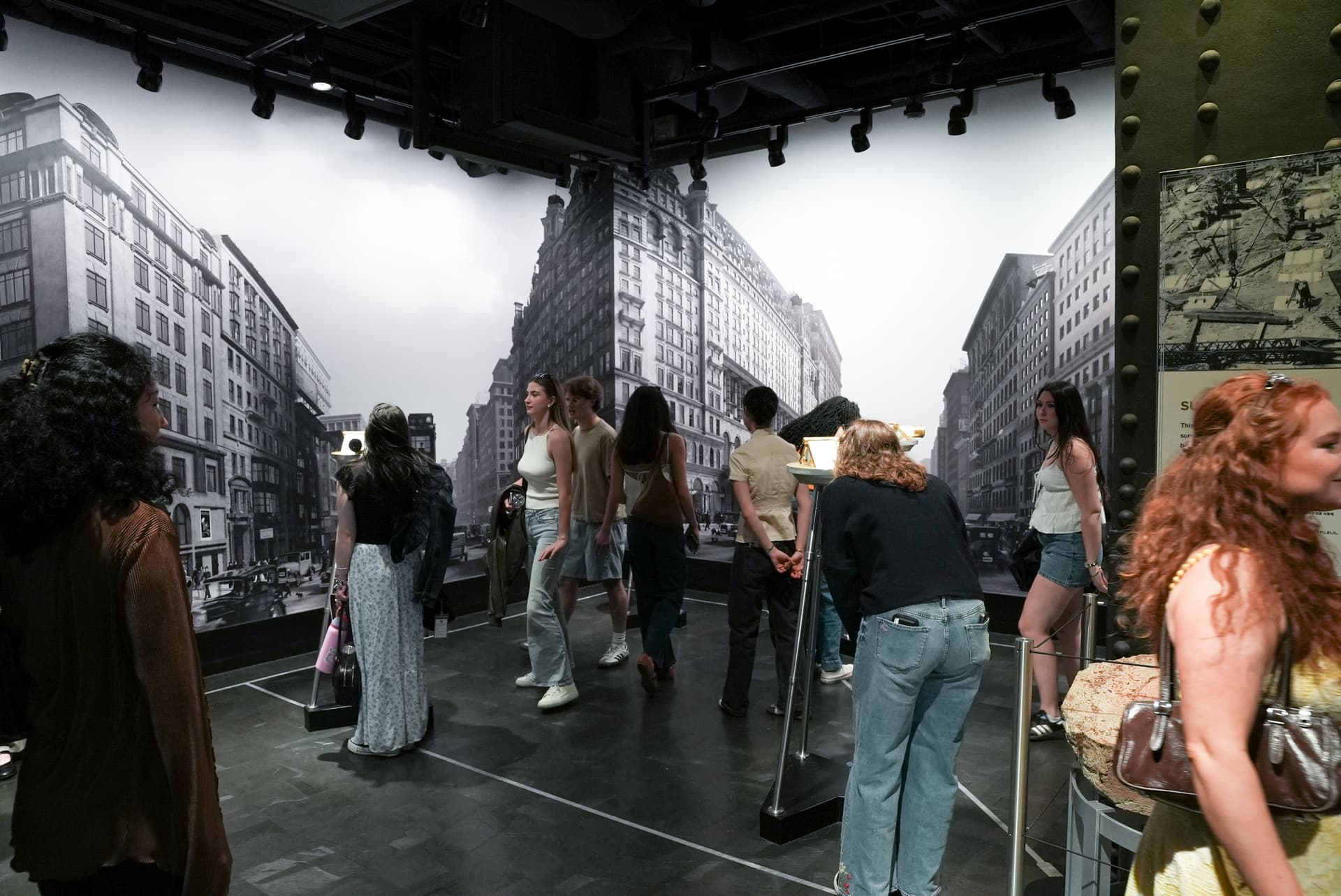 People looking through the Opening Day exhibit at the Empire State Building Observation Deck