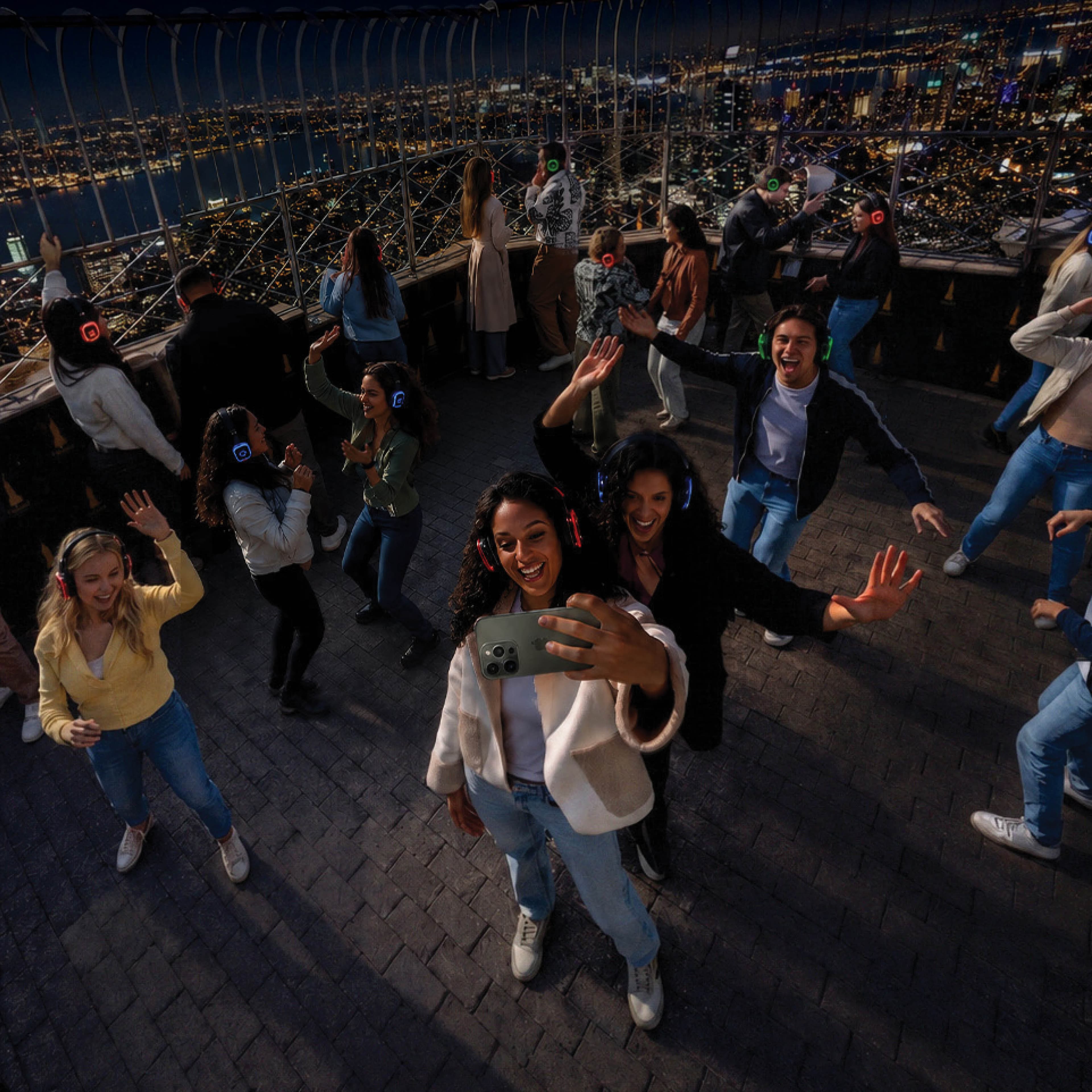 People dancing on the 86th Floor Observation Deck during NYC Silent Disco Night