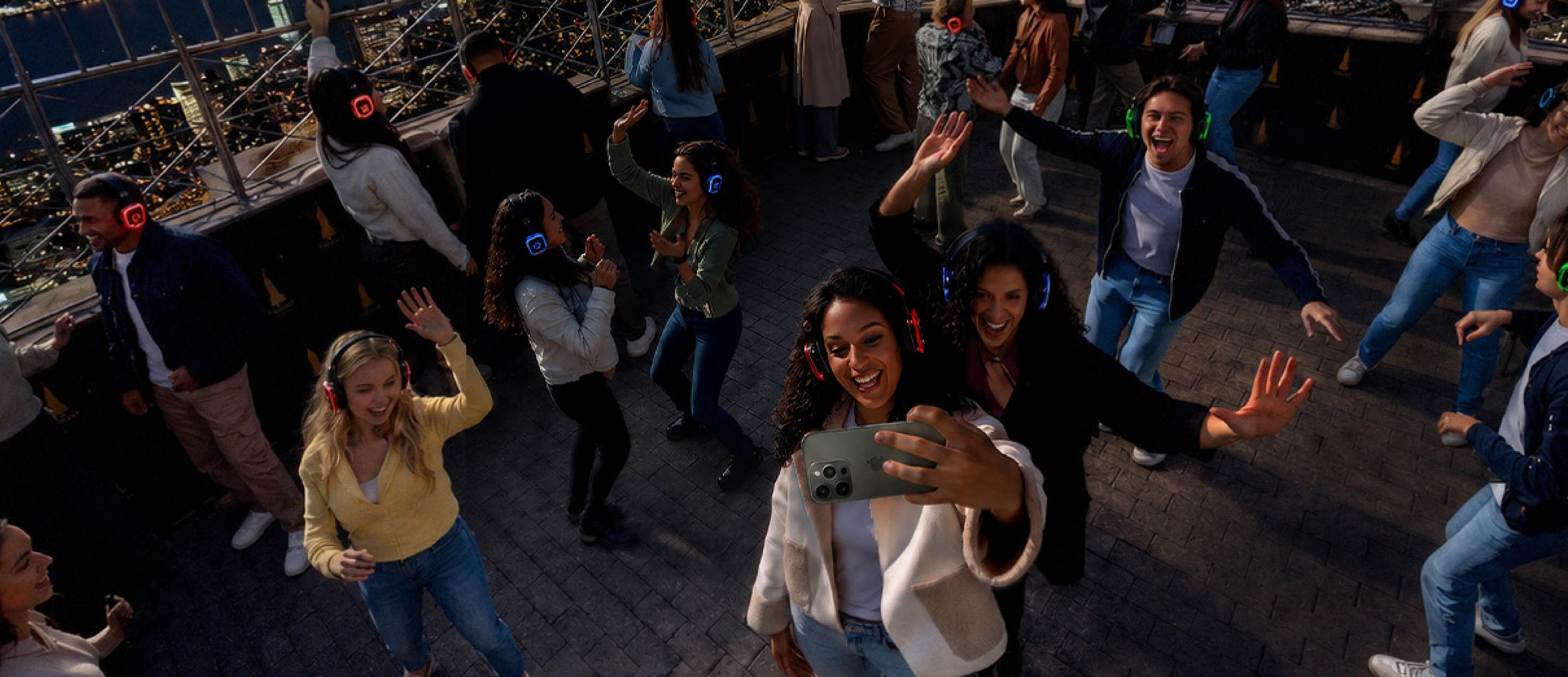 People dancing on the 86th Floor Observation Deck during NYC Silent Disco Night