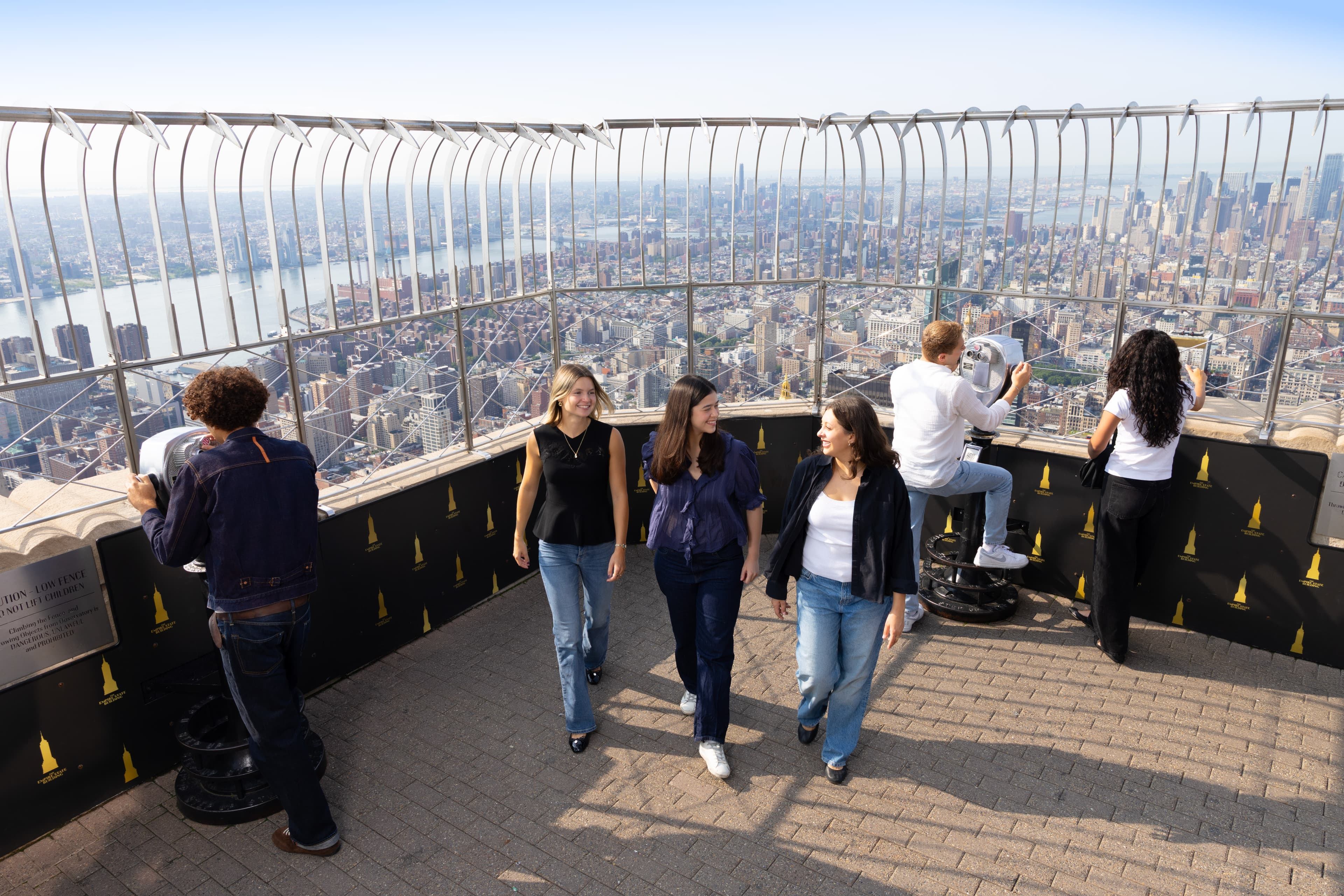 Three girls walking through the world-famous Empire State Building 86th Observation Deck, NYC's best observation deck