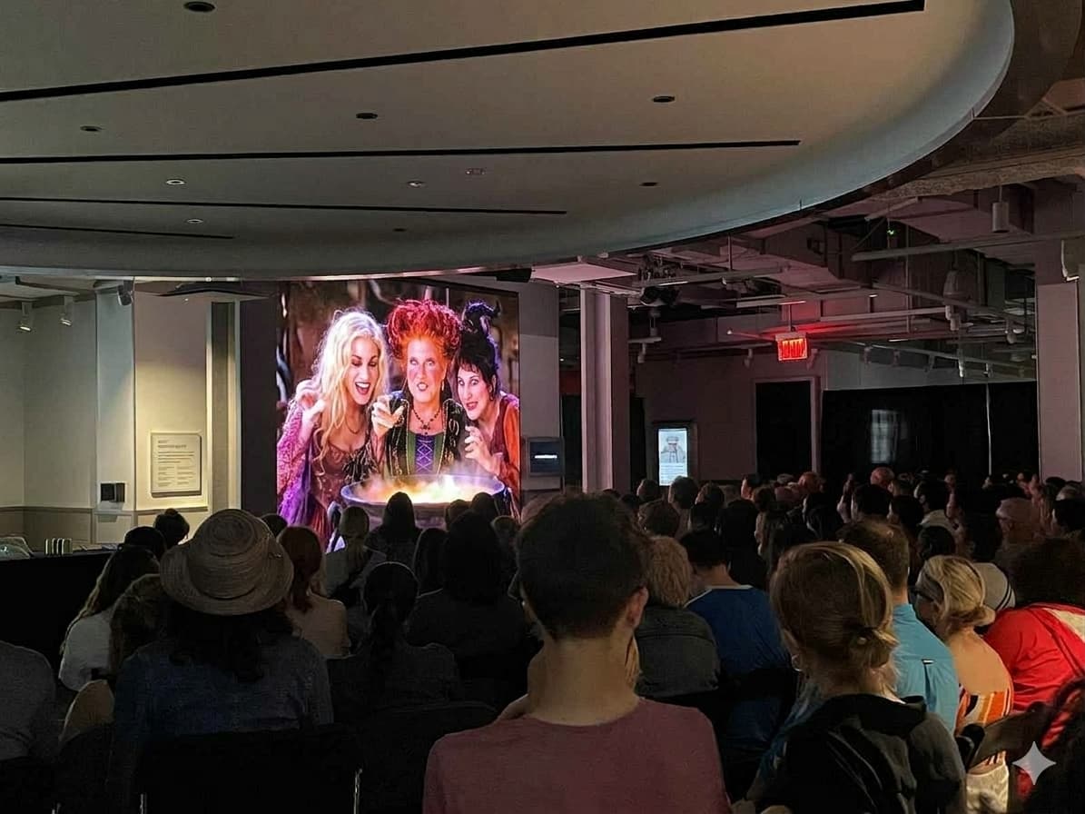 People watching Hocus Pocus on the screen at the Empire State Building Observation Deck's 80th Floor