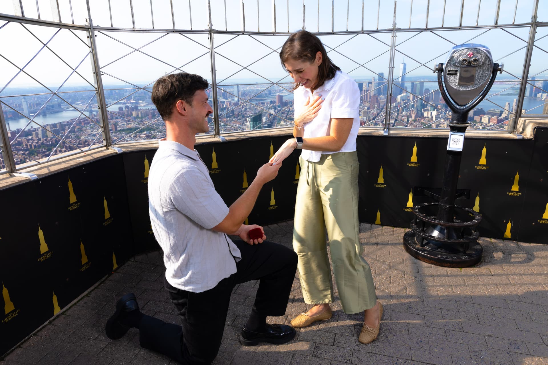 Man proposing to a woman on the 86th Floor Observation Deck of the Empire State Building