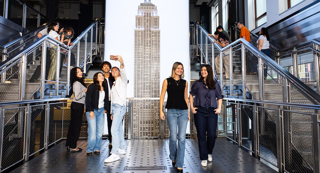 People walking around the Empire State Building Grand Staircase exhibit