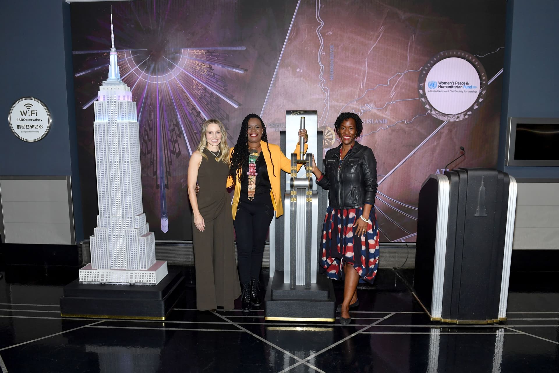 Kristen Bell, Pascale Solages, and Tonni Ann Brodber light the Empire State Building