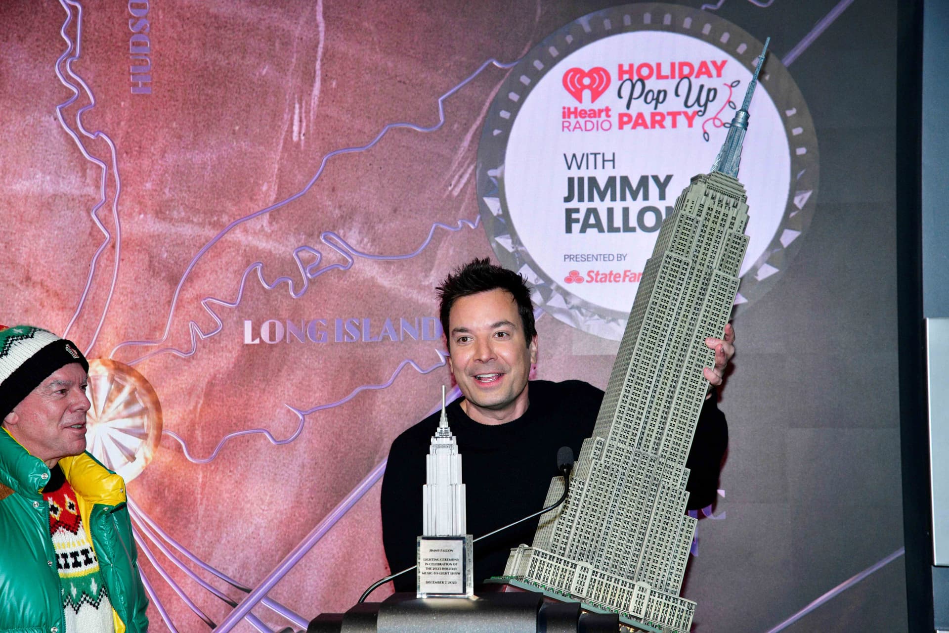 Jimmy Fallon holding a model of the Empire State Building