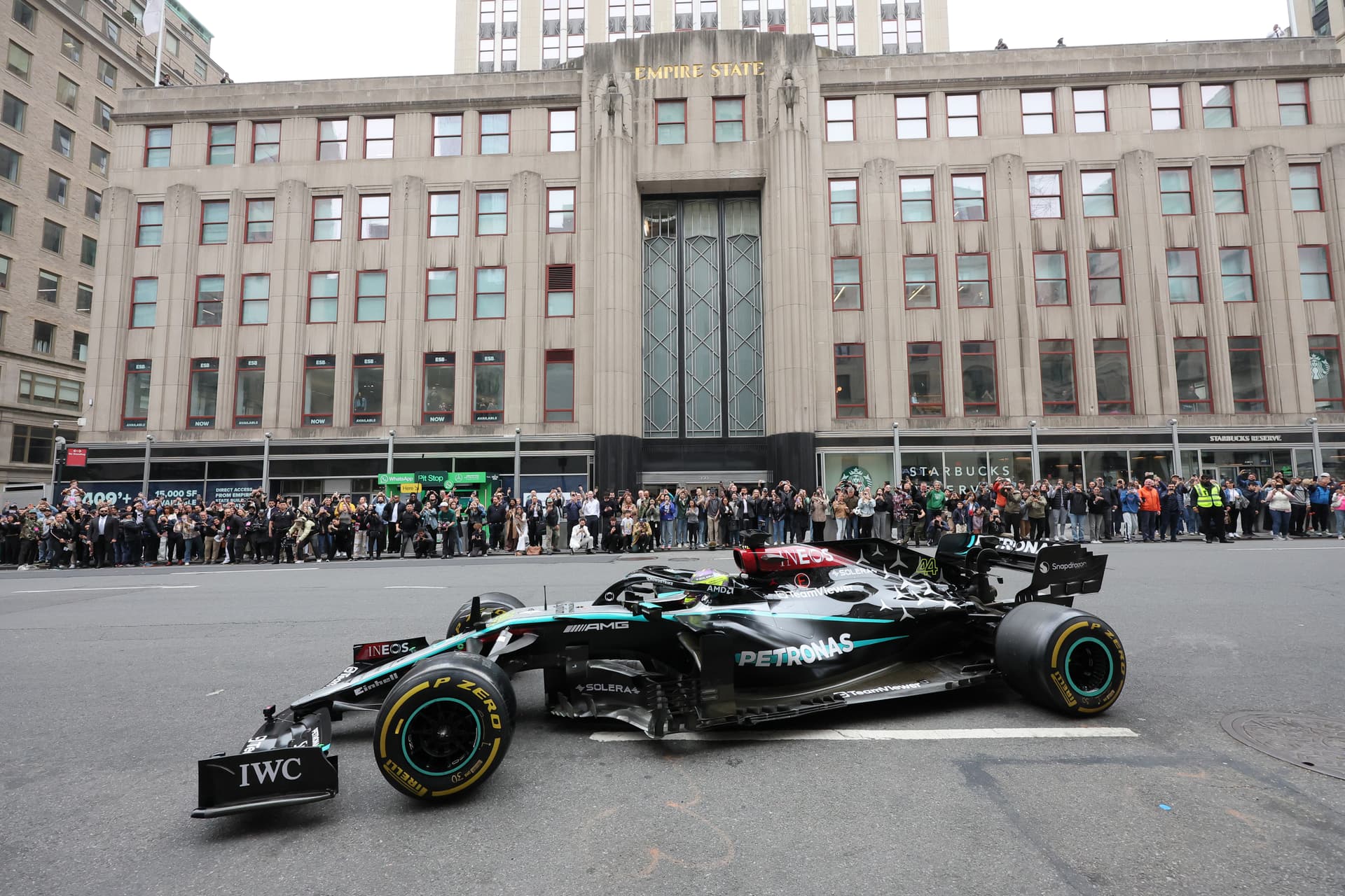 Lewis Hamilton drives a Mercedes-AMG F1 car in front of ESB