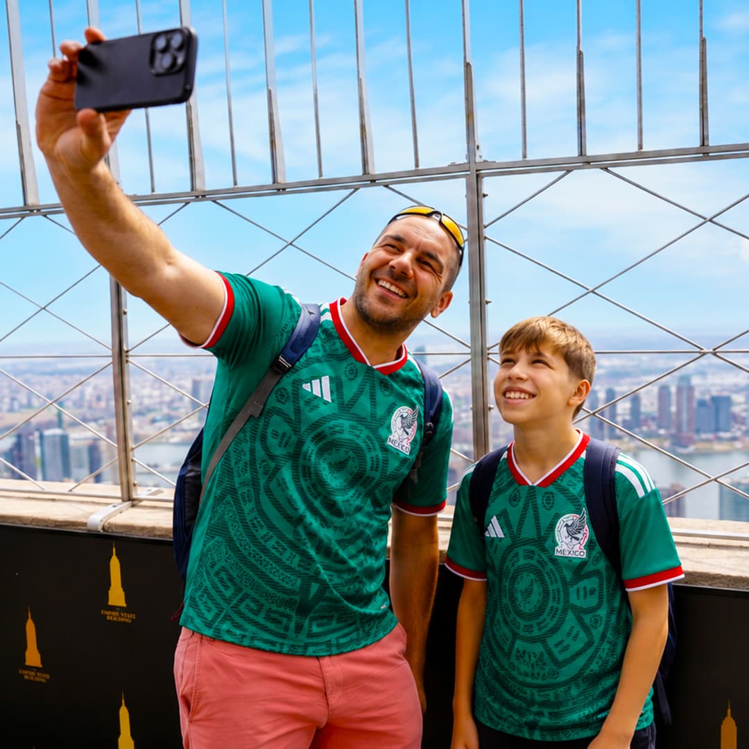 Dad and son on 86th Floor in soccer jerseys