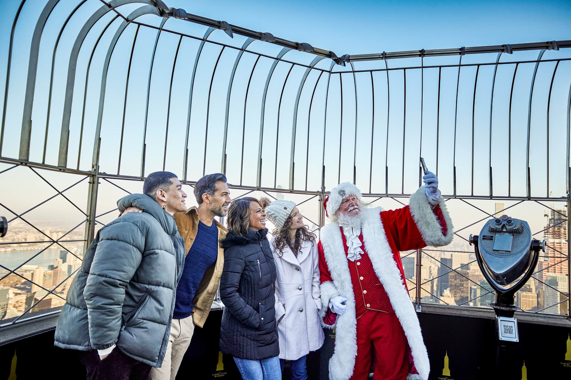 Santa poses for a photo with a family