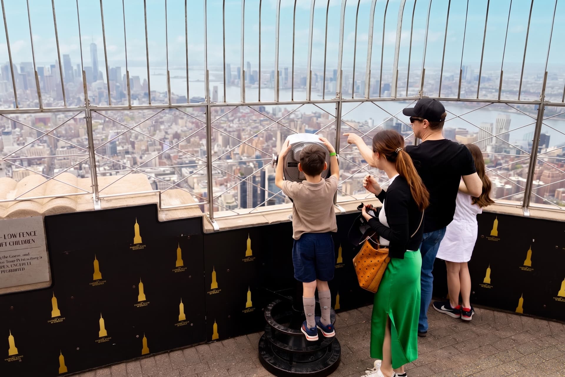 Family looks out at the skyline from the Empire State Building Observation Deck