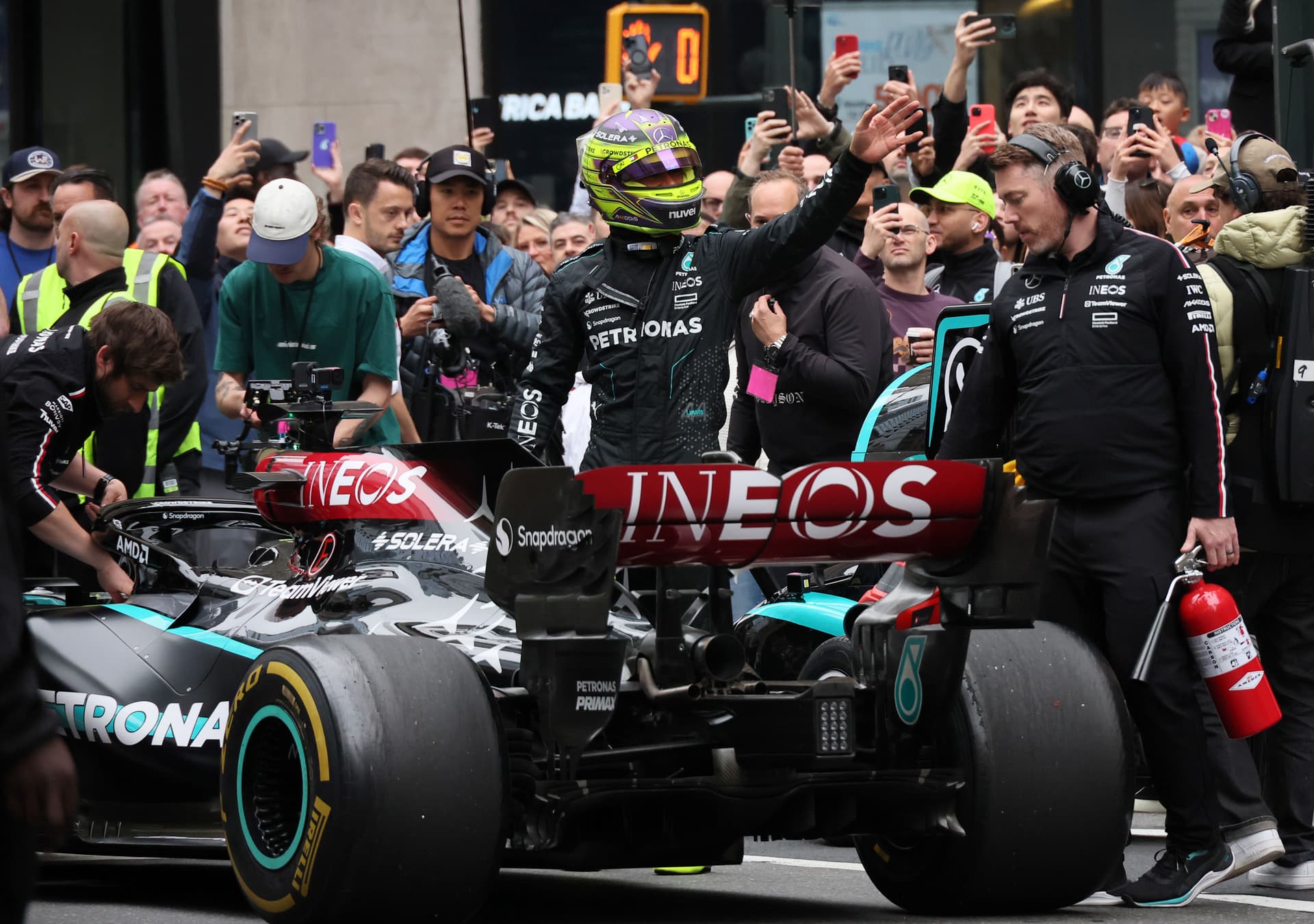 Lewis Hamilton waves to fans after historic stunt
