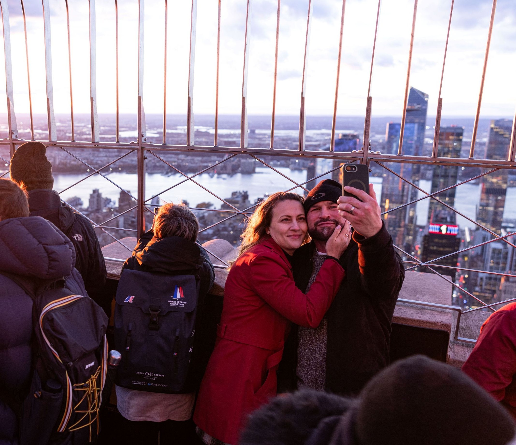 Guests taking a selfie on the 86th Floor Observation Deck at the Empire State Building Observatory.