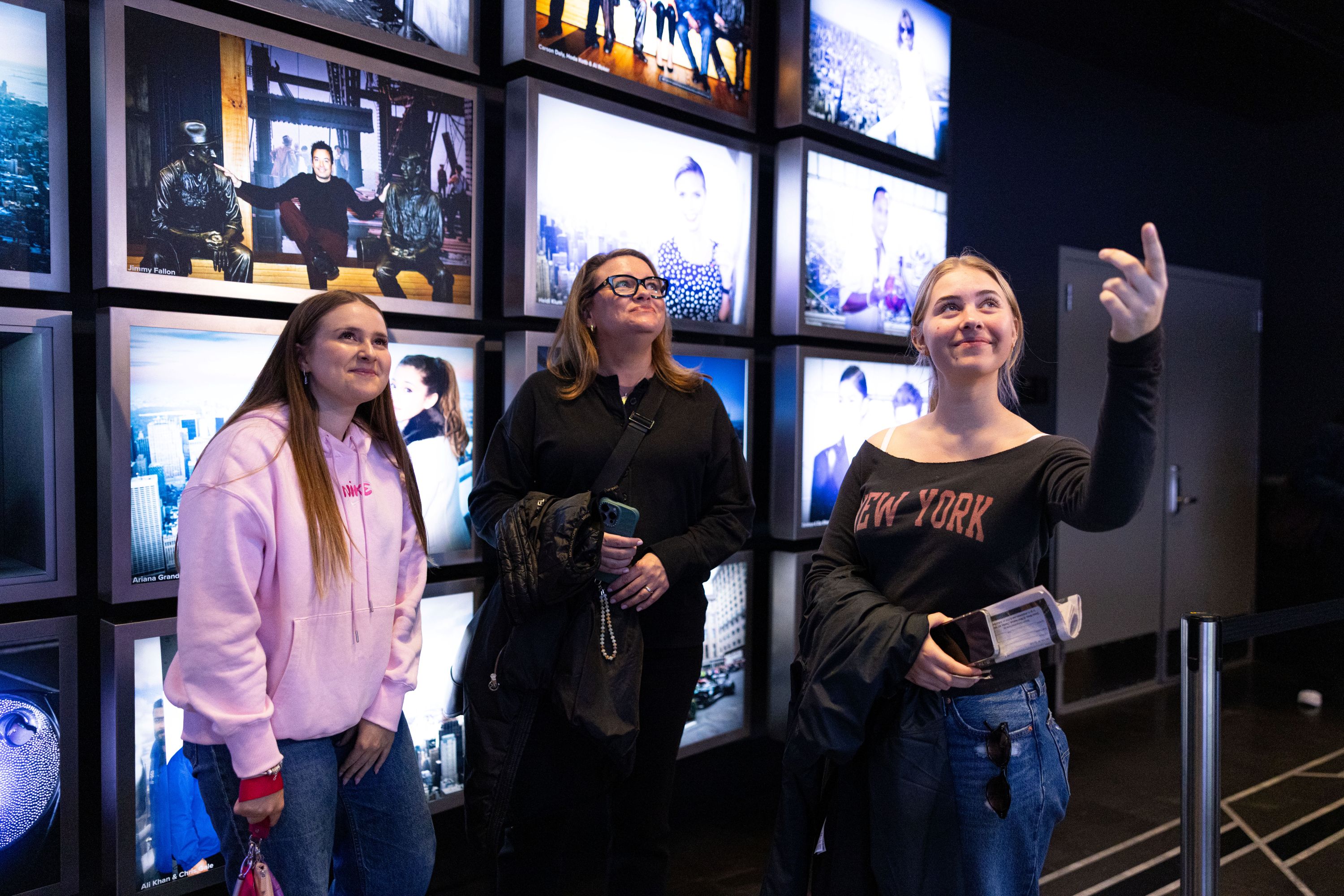 People experiencing the celebrities exhibit in the Empire State Building Observatory museum experience.