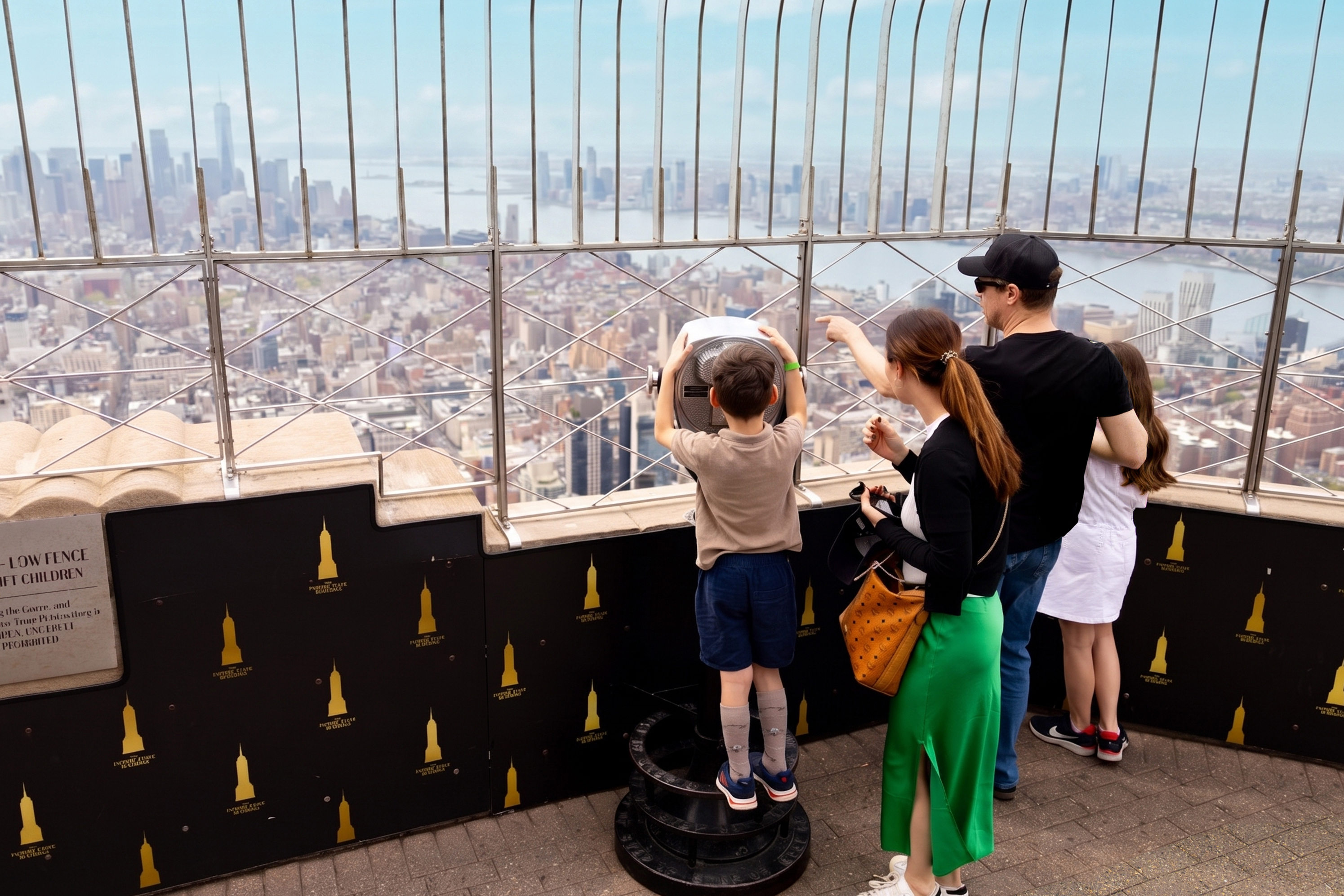 Family looks out at the skyline from the Empire State Building Observation Deck