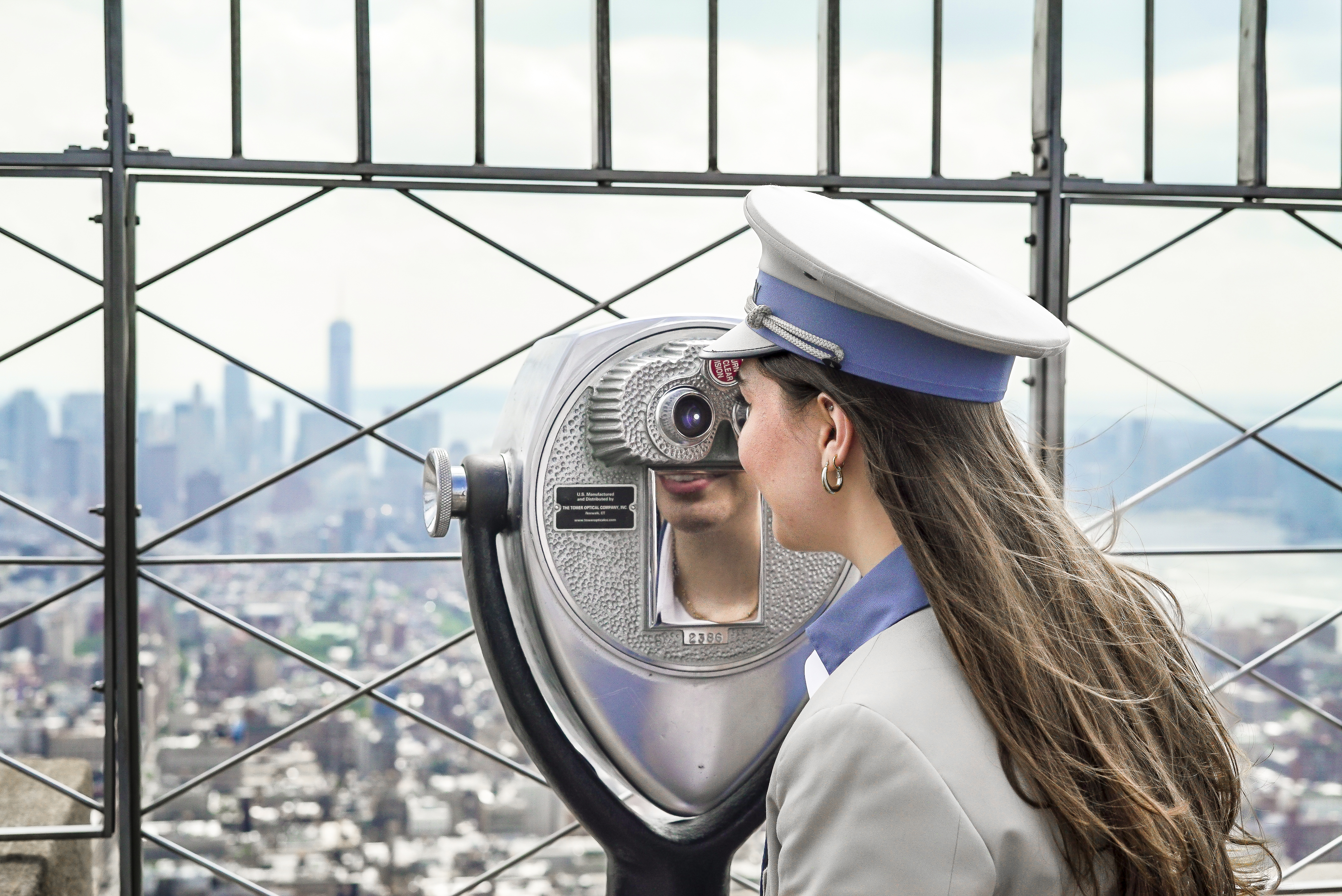 person looking into viewfinder on 86th floor observation deck