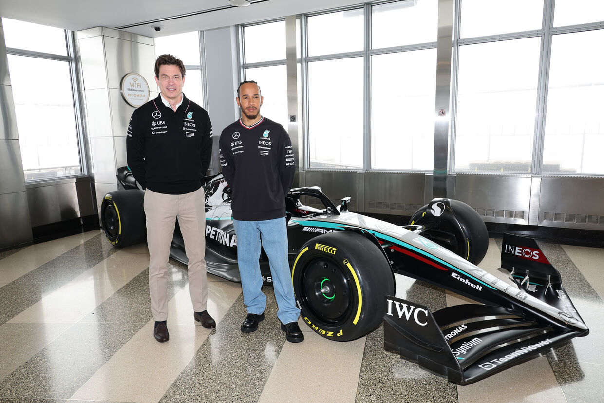 Toto Wolff and Lewis Hamilton with an F1 car on the 86th Floor