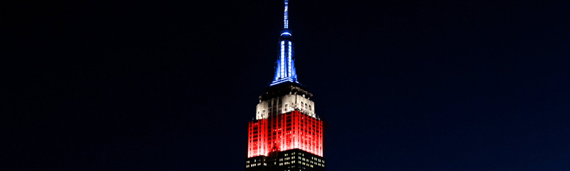 The Empire State Building lit in red, white, and blue