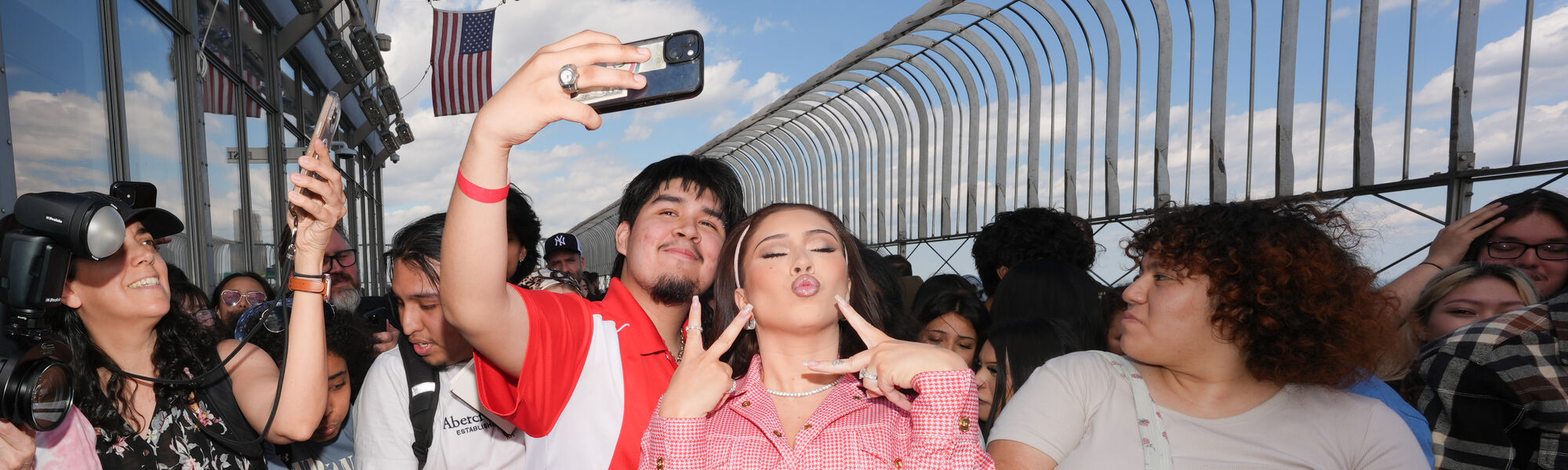 Kali Uchis poses with fans on the 86th Floor Observatory