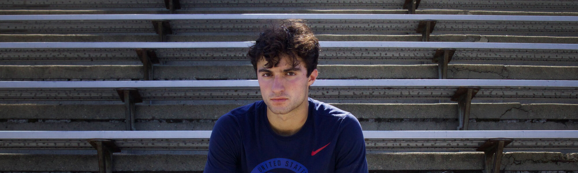 Ezra Frech poses on bleachers