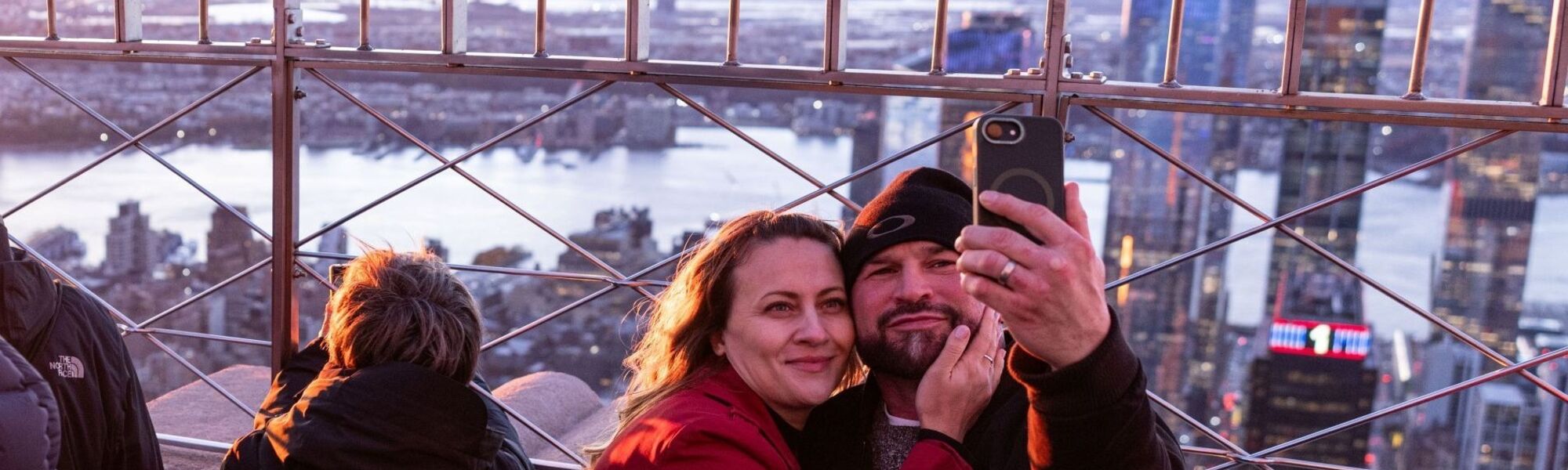 Guests taking a selfie on the 86th Floor Observation Deck at the Empire State Building Observatory.