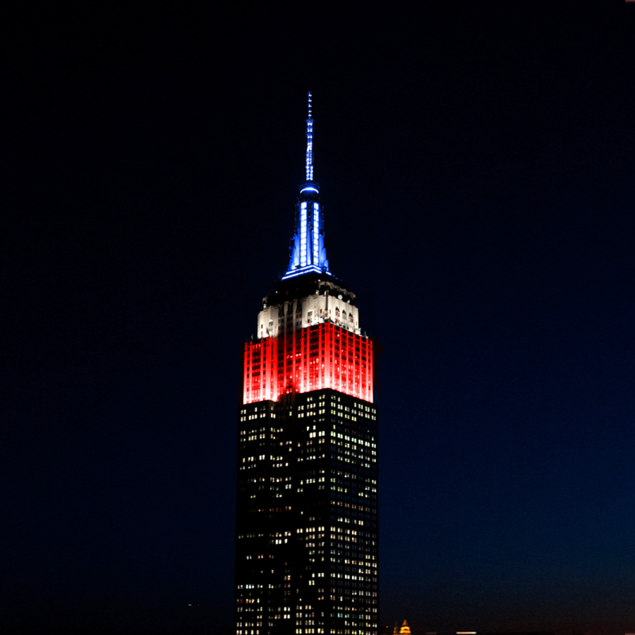 The Empire State Building lit in red, white, and blue
