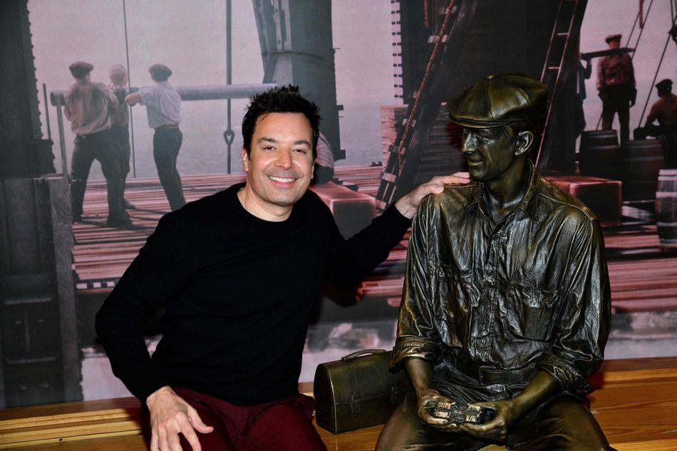 Jimmy Fallon poses with a bronze statue at the ESB Observatory