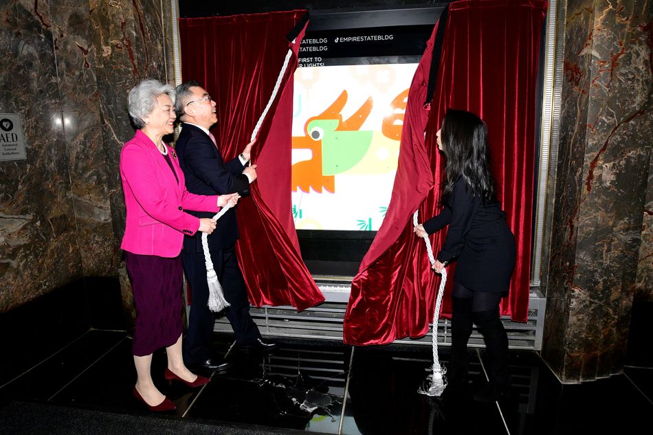 Counsel General Huang Ping, Madame Zhang Aiping, and ESRT EVP, COO & CFO Christina Chiu unveil the Lunar New Year windows at ESB.