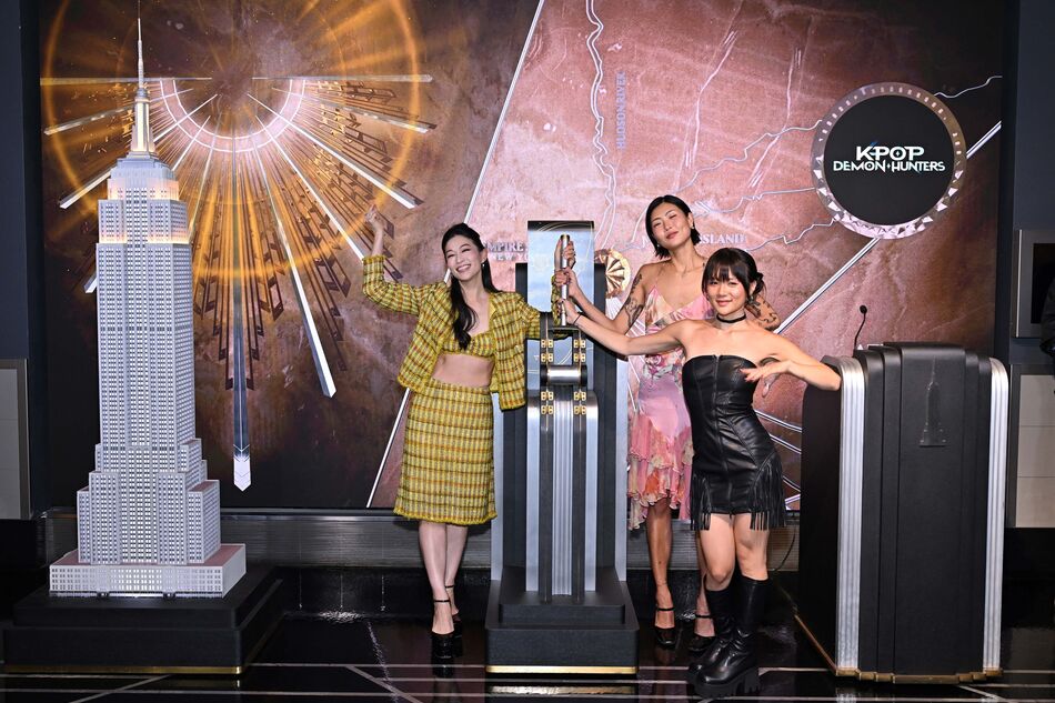 Arden Cho, May Hong, and REI AMI light the Empire State Building
