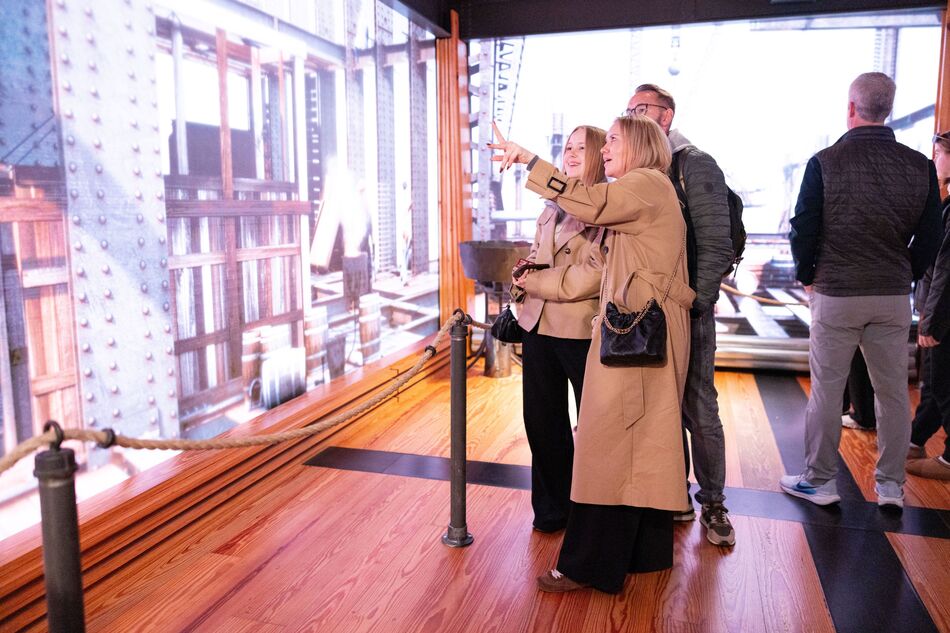 Family observing the construction exhibit on the second floor of the Empire State Building Observatory experience