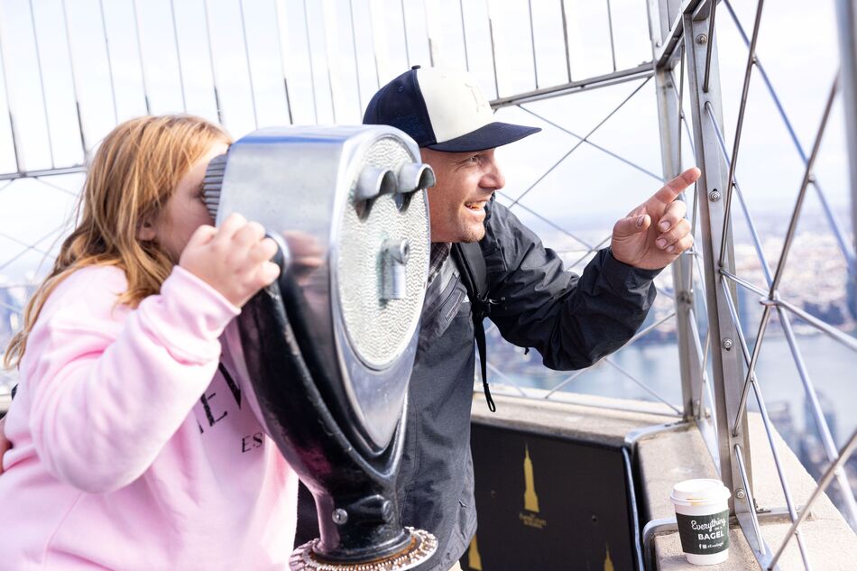 Person observing the view looking through a viewfinder on the 86th Floor of the empire state building observatory