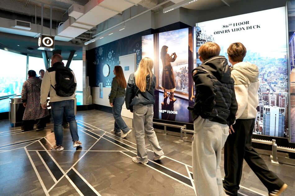 people walking to the ticketing center before entering the second floor museum experience at the empire state building observatory