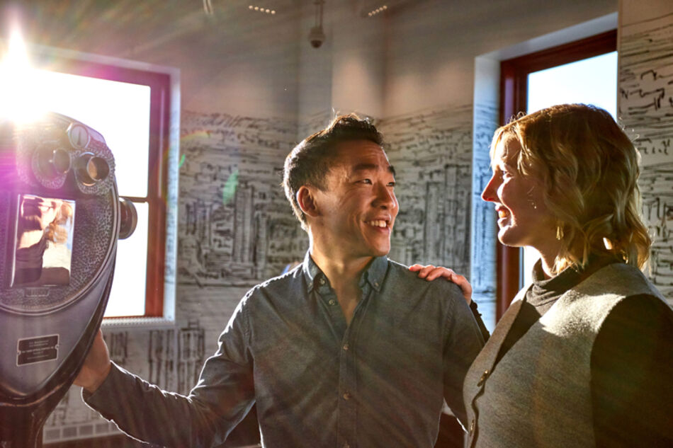 couple enjoying the empire state building's 80th floor 