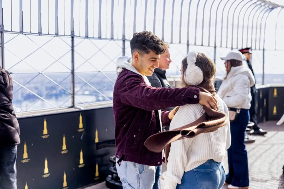 couple enjoying the empire state building's 86th floor observation deck