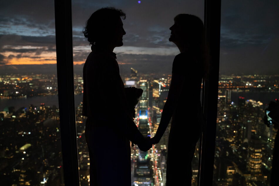 couple enjoying the empire state building's 102nd floor Observatory