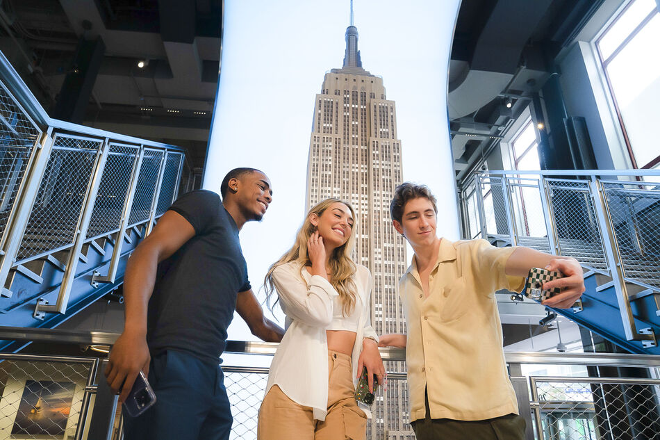 People taking photos at the grand staircase at the Empire State Building Observatory museum experience