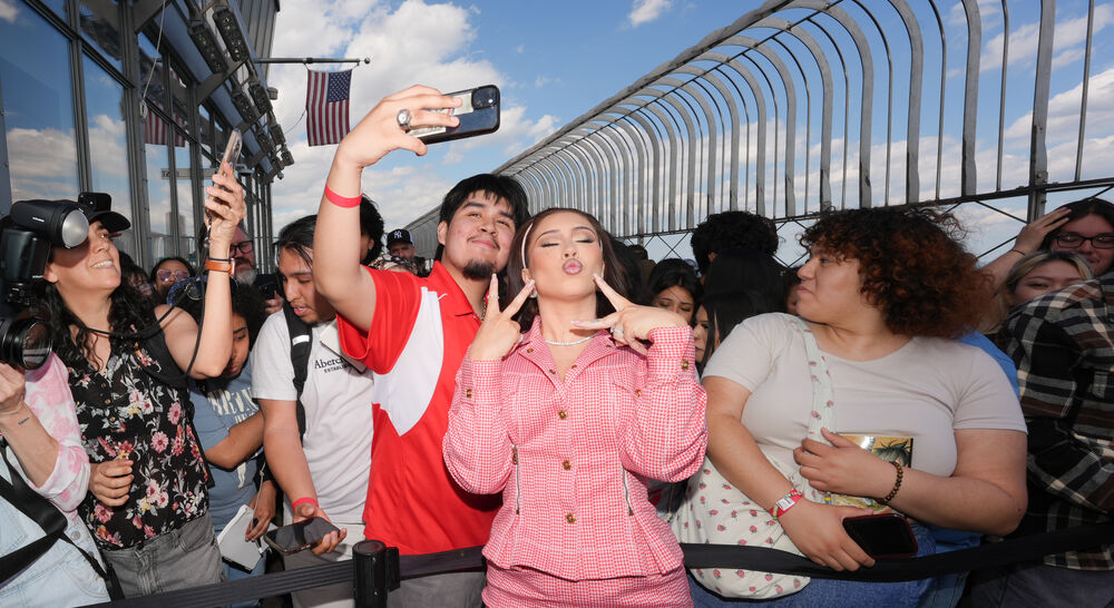 Kali Uchis poses with fans on the 86th Floor Observatory