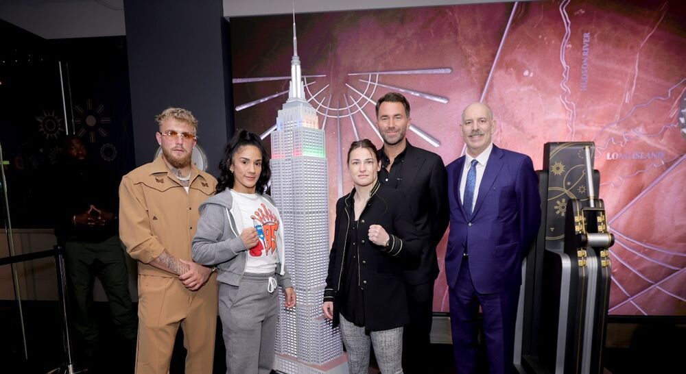 Katie Taylor, Amanda Serrano, Jake Paul pose for a picture at the Empire State Building lighting ceremony
