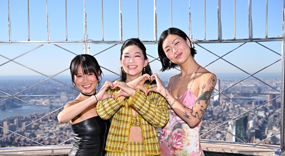 Arden Cho, May Hong, and REI AMI on the 86th Floor Observatory