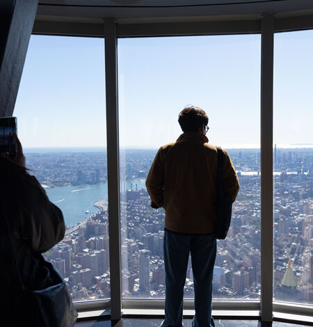 Person observing the view from the 102nd floor of the empire state building observatory