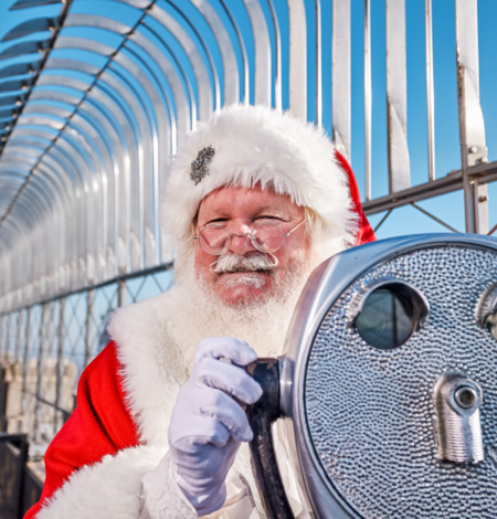 Santa posing behind a viewfinder on the 86th floor at the Empire State Building Observatory