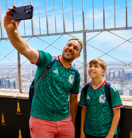 Dad and son on 86th Floor in soccer jerseys
