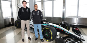 Toto Wolff and Lewis Hamilton with an F1 car on the 86th Floor