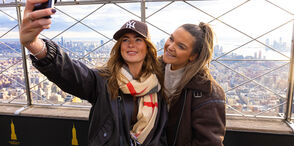 Two women on the 86th Floor Observation deck taking a selfie with the view at the EBSO