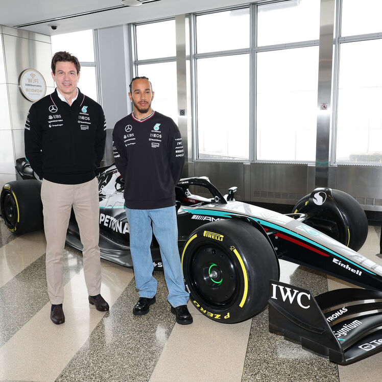 Toto Wolff and Lewis Hamilton with an F1 car on the 86th Floor