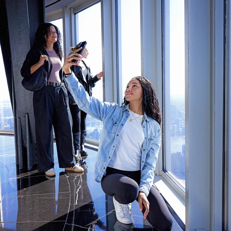 Girl taking selfie at the Empire State Building's 102nd Floor Observatory with nyc city views