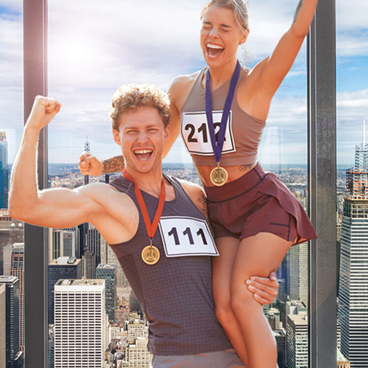 New York City Marathon Winners posing for a photo on the 102nd floor observation deck at the Empire State Building Observatory.