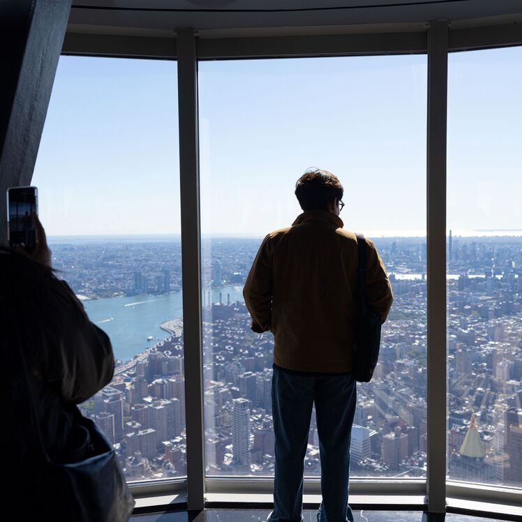 Person observing the view from the 102nd floor of the empire state building observatory